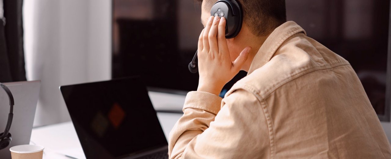 A producer checks a voiceover take against the script at a desk